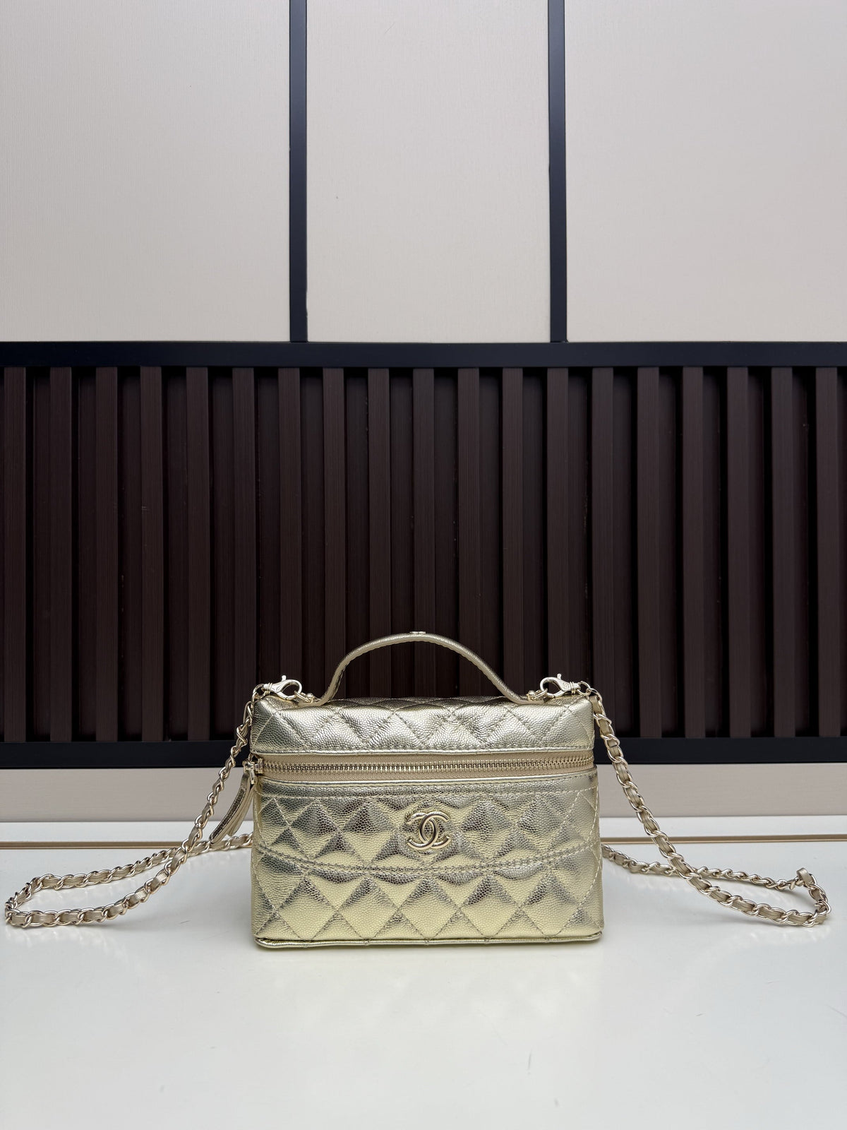 Gold metallic quilted vanity case with chain strap and top handle, diamond quilt pattern, gold-tone hardware