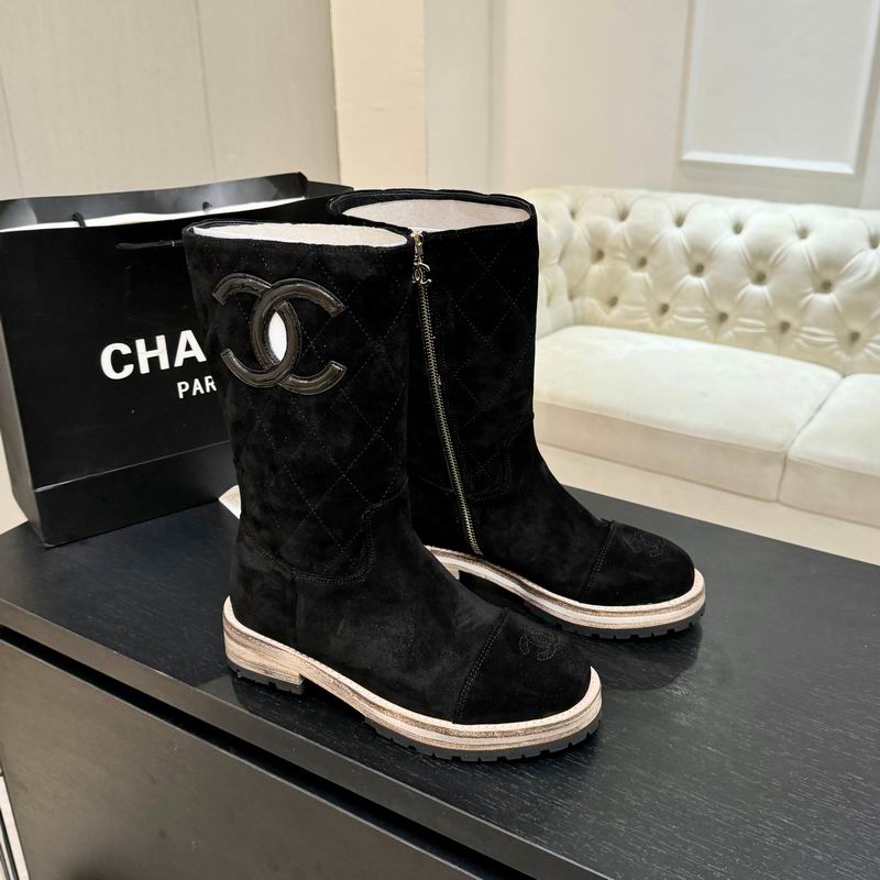 Black quilted suede mid-calf boots with shearling lining, silver-tone zipper, emblem detail, and two-tone lug sole